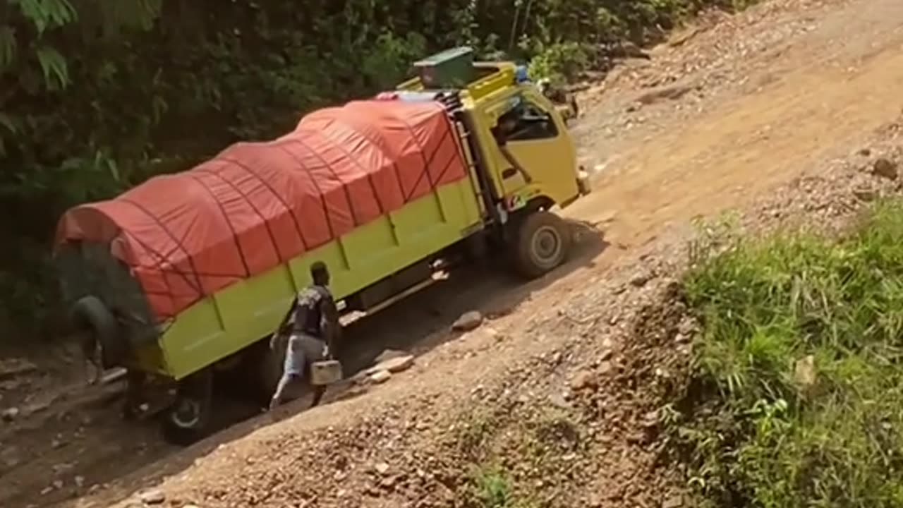 The truck goes up a steep road up a mountain