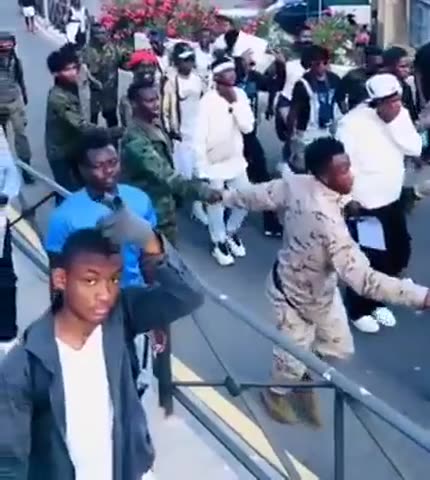 African immigrants arriving in Spain. Many of them are wearing military uniforms.