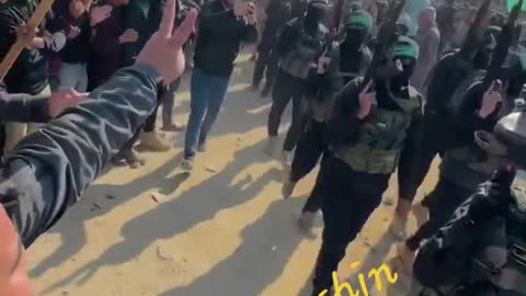 Thousands of Gazans line the streets to cheer and show their support for Hamas.