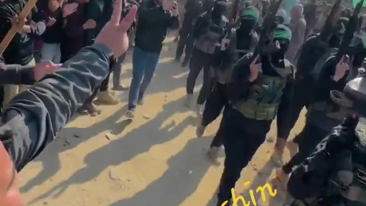 Thousands of Gazans line the streets to cheer and show their support for Hamas.