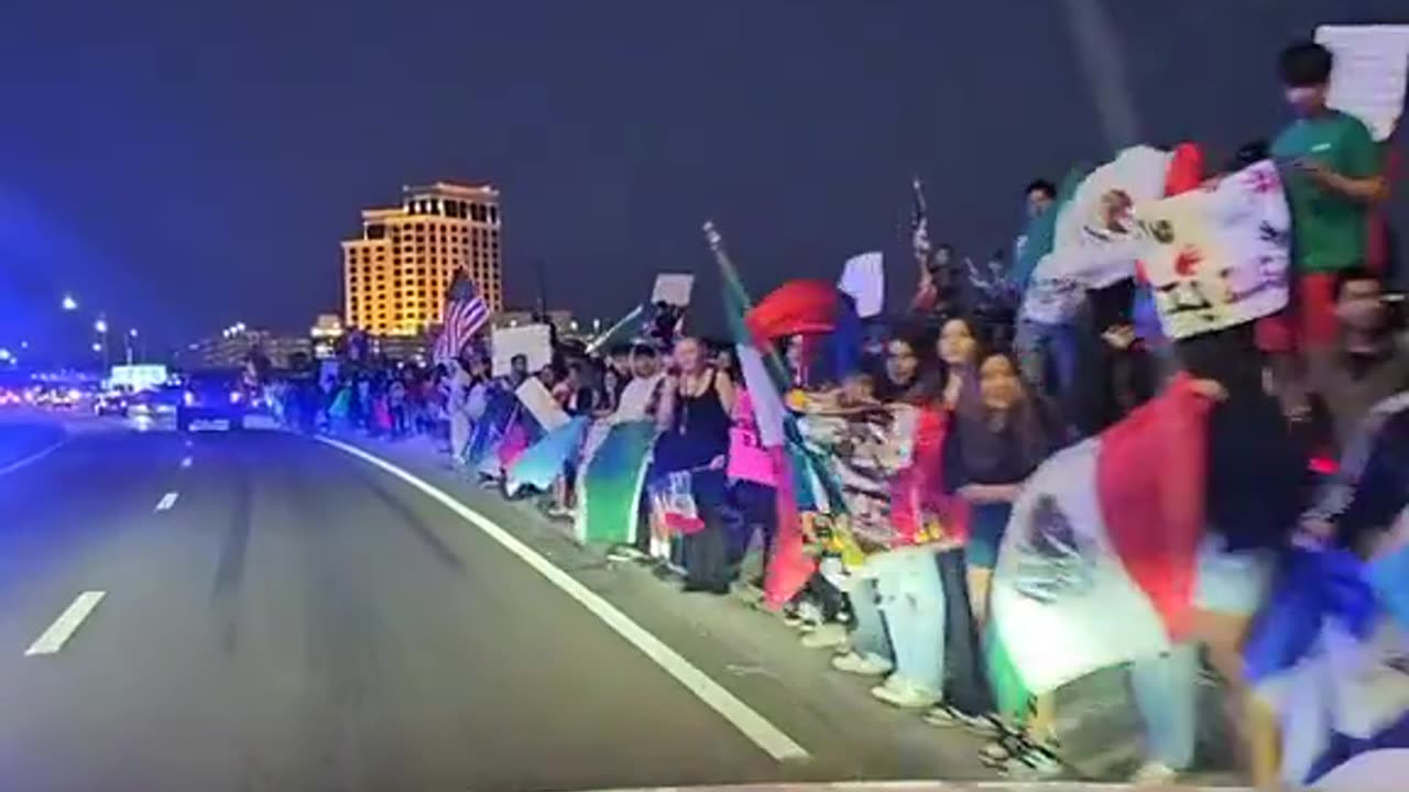 The driver is trolling the protesters by blasting “Ice Ice Baby.” Absolute legend.