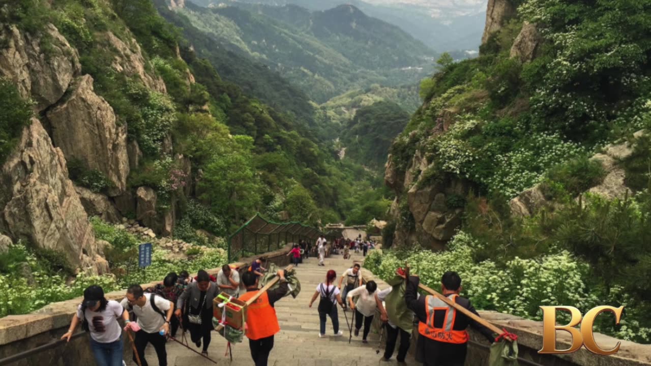 Robotic exoskeletons help Chinese tourists climb the country’s most punishing mountain