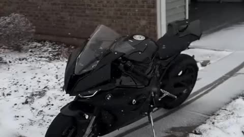 A dark horse in a snowstorm. #MotorcyclePhotography #BMWS1000RR