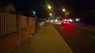 Two pairs of shoes on path near damaged sign, golden shoes left previously