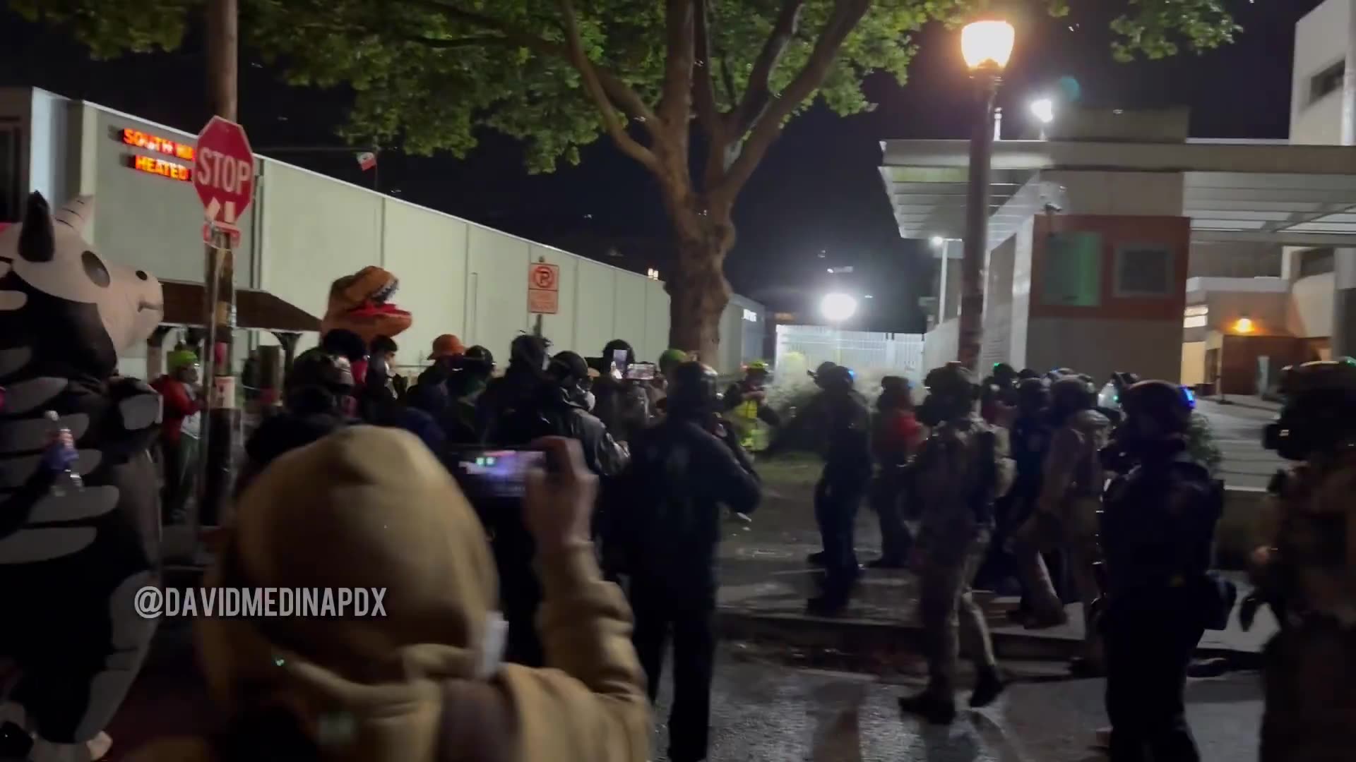 Federal officers rush rioters outside of the Portland ICE facility and make two arrests.