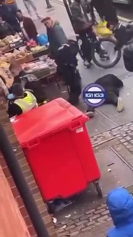 Black guy tries to stop his friend from being arrested by launching a bike at officers.mp4