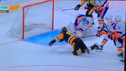 Islanders goalie #50 Marcus Hogberg stops Penguins #17 Bryan Rust with his stick.