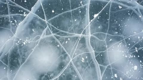 Close Up of Frozen Lake Surface with Cracks and Snow Dust
