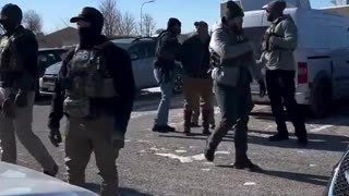 Ian Austin who stormed the church being arrested by the FBI.