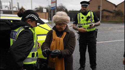 Elderly Woman Arrested In Scotland The Crime - Standing Silently With a Sign Near a Hospital