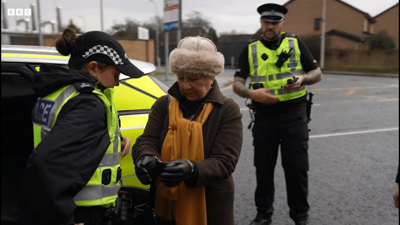 Elderly Woman Arrested In Scotland The Crime - Standing Silently With a Sign Near a Hospital
