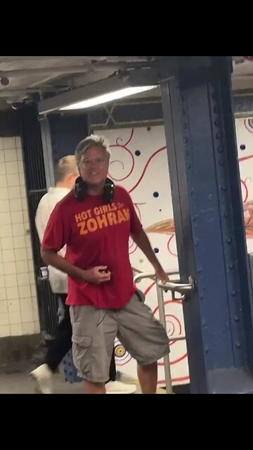 A man wearing a “Hot Girls for Zohran Mamdani” shirt