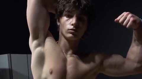 Young aesthetic bodybuilder flexing muscles