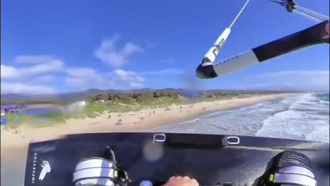 Kiteboarder Flies Beneath Windsurfer