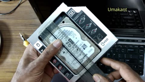 Measuring 2.5 Inch Hard Disk And Optical Sata Caddy (For 12.7Mm Dvd Drive) On Scale