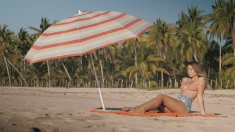 woman-tanning-at-the-beach