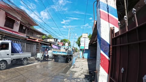 Crossing The Wet Road on Hipolito Street in Malolos, Bulacan, Philippines