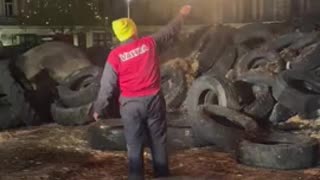 Farmer protesting in France burns the European Union flag