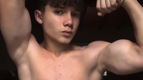 Teen boy flexing muscles