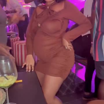 Pregnant woman inbthe club dancing.