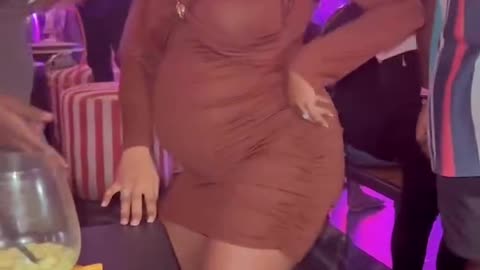 Pregnant woman inbthe club dancing.