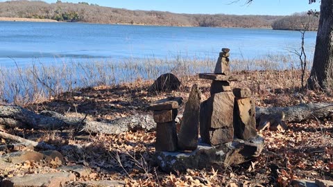 ...stone balancing temple building at a lake...