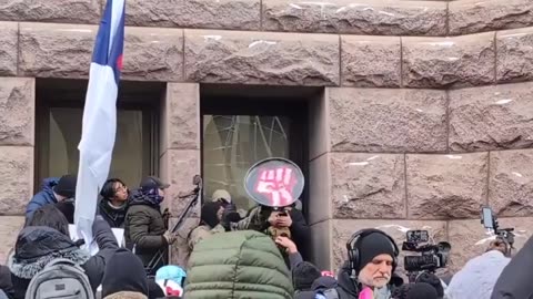 Right-wing influencer Jake Lang is surrounded outside Minneapolis City Hall