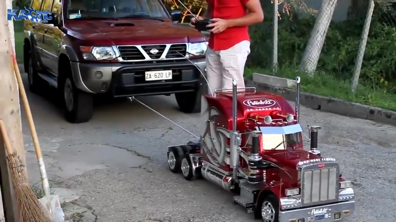 A Functioning 1⧸4 Scale Peterbuilt Truck Model Pulling a 4x4 SUV