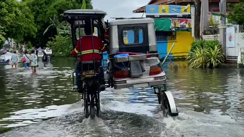 Lifted Autorickshaw Drives Through Floodwater