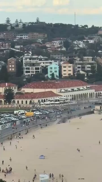 People running and taking cover after mass shooting at Bondi Beach