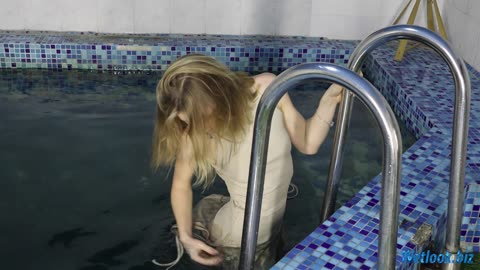 Wetlook girl in dress gets wet in the Pool