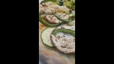 Eggplant zucchini onion broccoli green pepper red pepper flake pizza