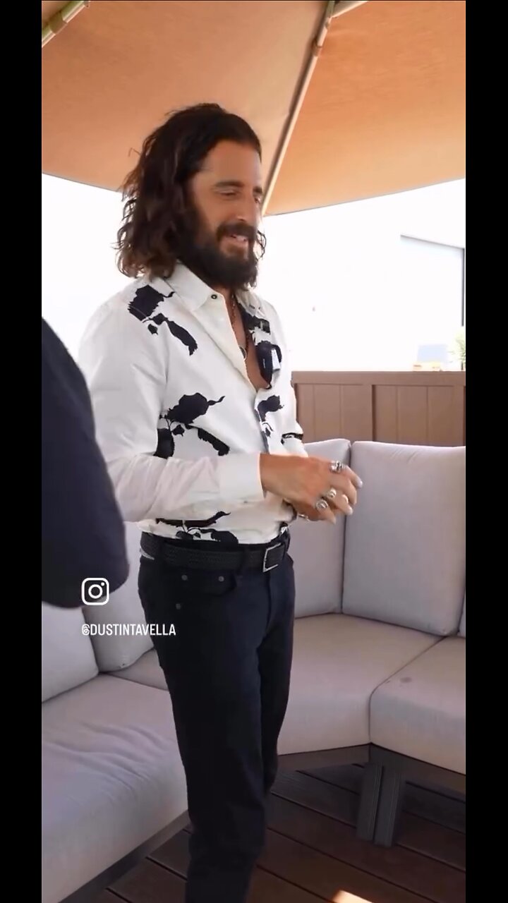 Jonathan Roumie unique posture-a magician with playing cards