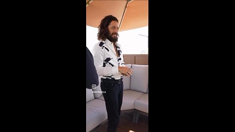 Jonathan Roumie unique posture-a magician with playing cards