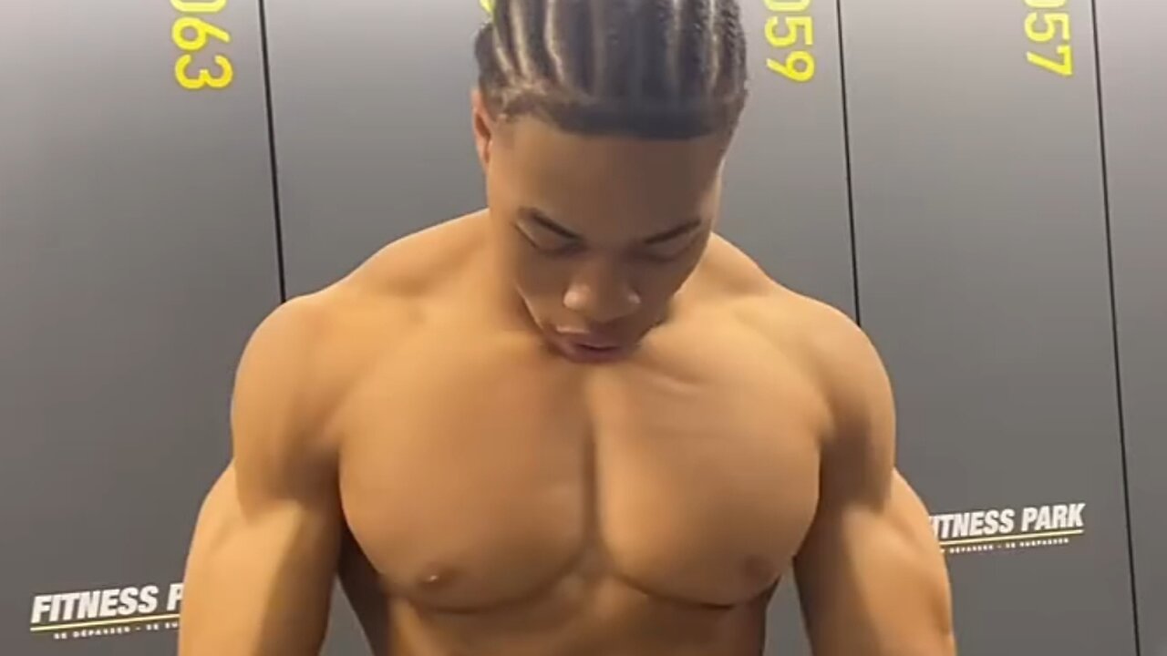 18 years old bodybuilder flexing muscles