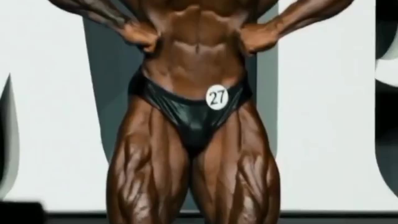chris bumstead stage posing on olympia