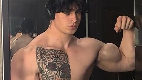 Young man flexing muscles