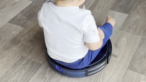 Boy Riding Robot Vacuum Bumps Toes