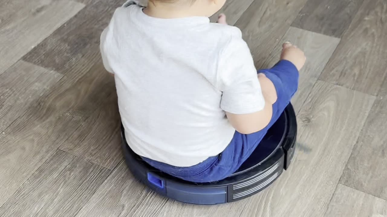 Boy Riding Robot Vacuum Bumps Toes