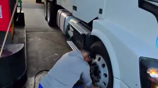 Illegal truck drivers unable to speak English trying to inflate a damaged tire