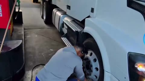 Illegal truck drivers unable to speak English trying to inflate a damaged tire