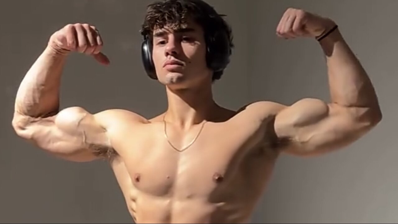 Young aesthetic bodybuilder flexing muscles