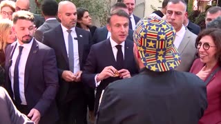 Macron shakes hands, eats food on walkabout in Beirut