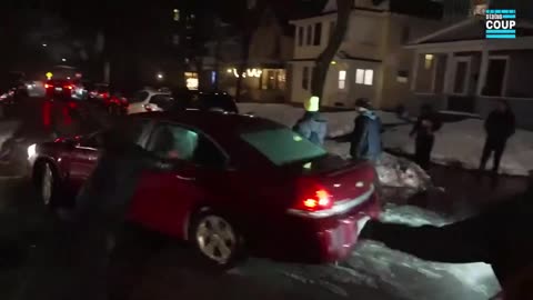 Car drives through Minneapolis protesters