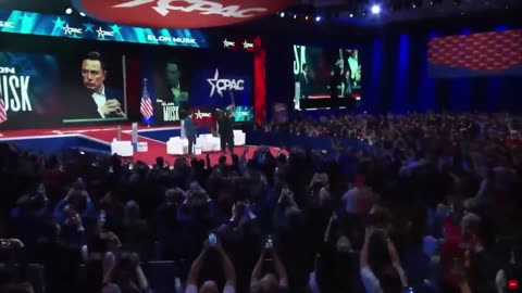 elonmusk is handed a chainsaw by JMilei at CPAC.