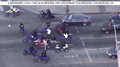 Pursuit involving nearly 20 dirt bikes in Los Angeles, California area; seen