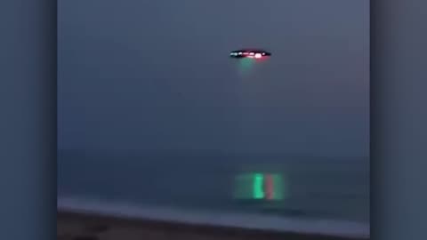 Brightly Lit Saucer over the Ocean