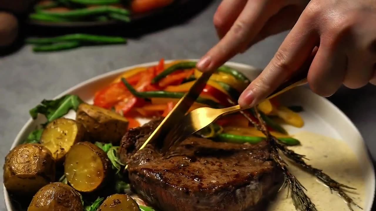 Steak with veggies, rosemary potatoes, and cream sauce