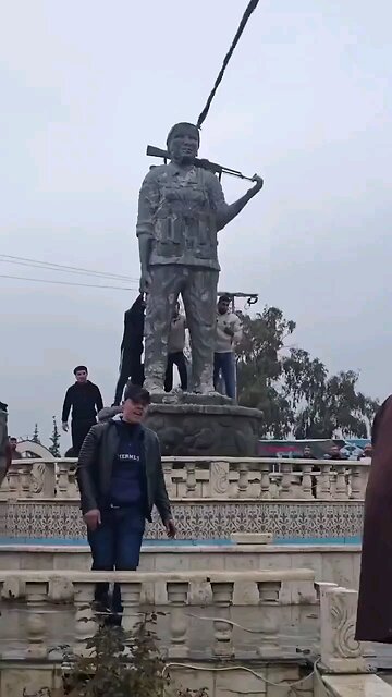 Syrian Government troops tear down a Women’s Protection Units (YPJ) (Kurdish women forces)