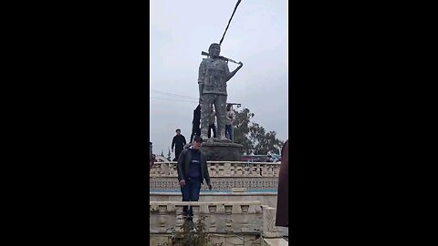 Syrian Government troops tear down a Women’s Protection Units (YPJ) (Kurdish women forces)